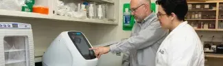 A U N E student works in a faculty research lab